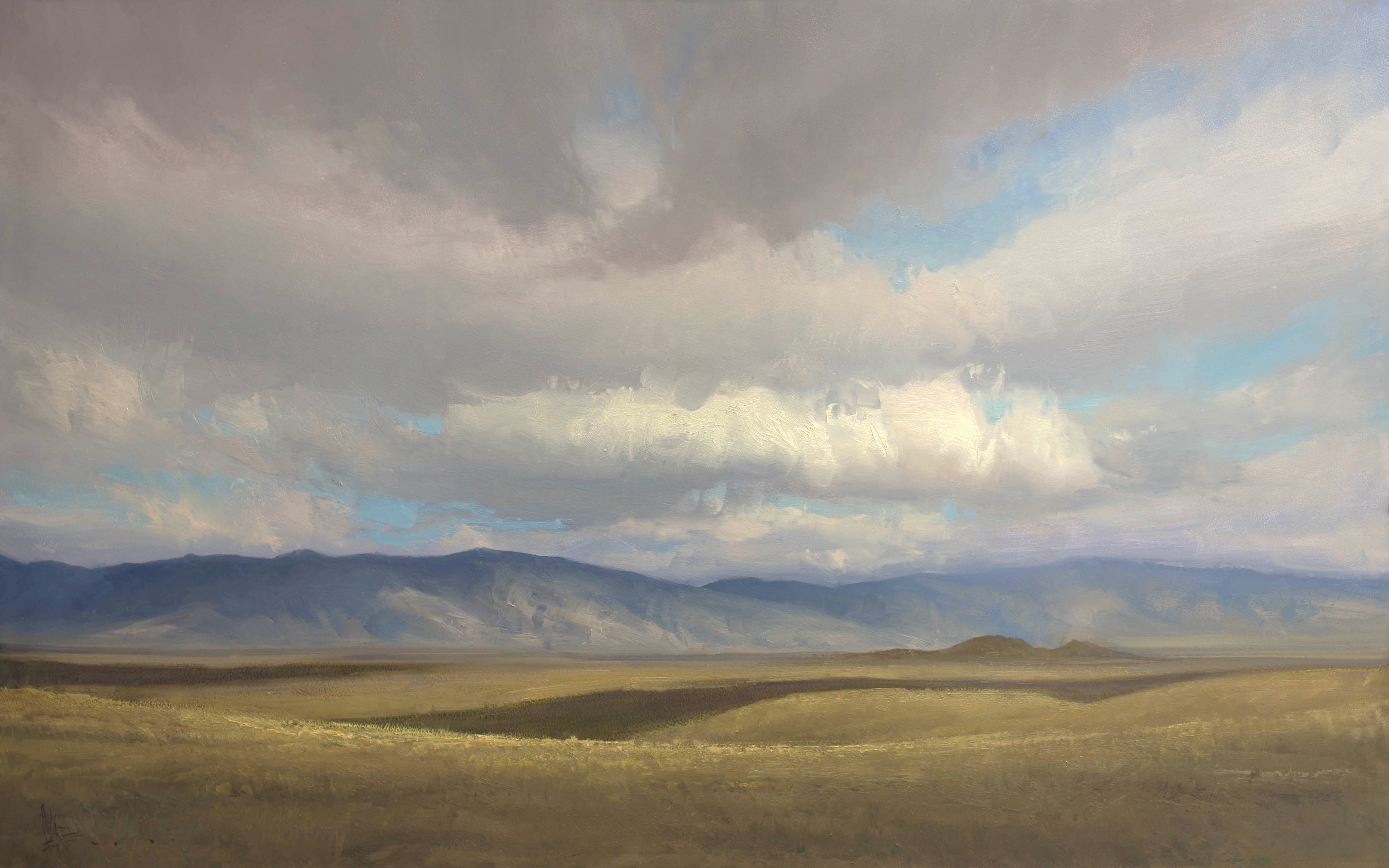 Plains and mountains in Casper, Wyoming. There are clouds in the sky.