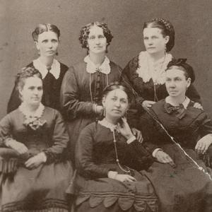 Circa 1872. Top row, left to right: Emmeline B. Wells, assistant secretary; Elizabeth H. Goddard, secretary; Mary W. Musser, treasurer. Bottom row: Margaret T. Mitchell, second counselor; Rachel Ivins Grant, president; Bathsheba W. Smith,  first counselor. Photograph by Charles R. Savage studio. (Church History Library, Salt Lake City.)