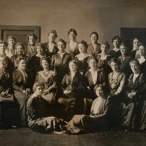 Circa 1905. The first YLMIA general board was organized in 1880 under Elmina S. Taylor. The board members traveled, coordinated the efforts of local associations, corresponded with local units, conducted training, developed curriculum and programs, and spoke at MIA June Conferences starting in 1896. Included in this photo are the following women who are mentioned in <i>At the Pulpit:</i> Maria Y. Dougall (seated row, first on right), Emma N. Goddard (seated row, second from right), Ann M. Cannon (seated row, third from right), Mattie Horne Tingey (seated row, fifth from right), Ruth May Fox (seated row, sixth from right), May Booth Talmage (first standing row, fifth from right), and Minnie J. Snow (second standing row, first on right). Tingey was YLMIA general president at the time this photo was taken.
