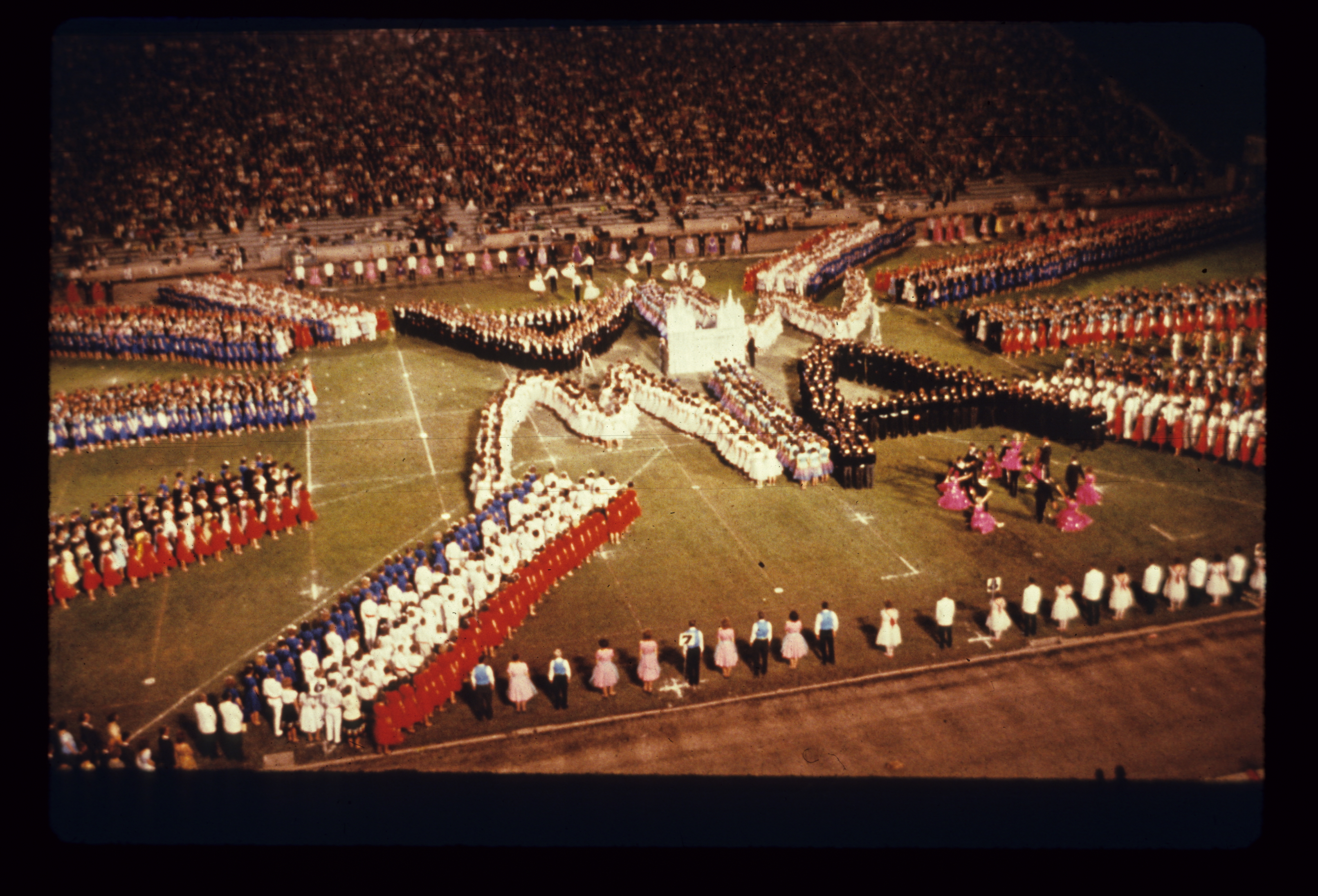 <strong>June Conference dance festival, University of Utah Ute Stadium.</strong> 1963. Spectators of the June Conference dance festival filled the Ute Stadium (now the Rice-Eccles Stadium) to its thirty-thousand-person capacity to watch thousands of youth dance in varying styles and formations. The yearly event became so popular that by the mid-1950s it was televised throughout Salt Lake City. (Image courtesy Church History Library, Salt Lake City.)