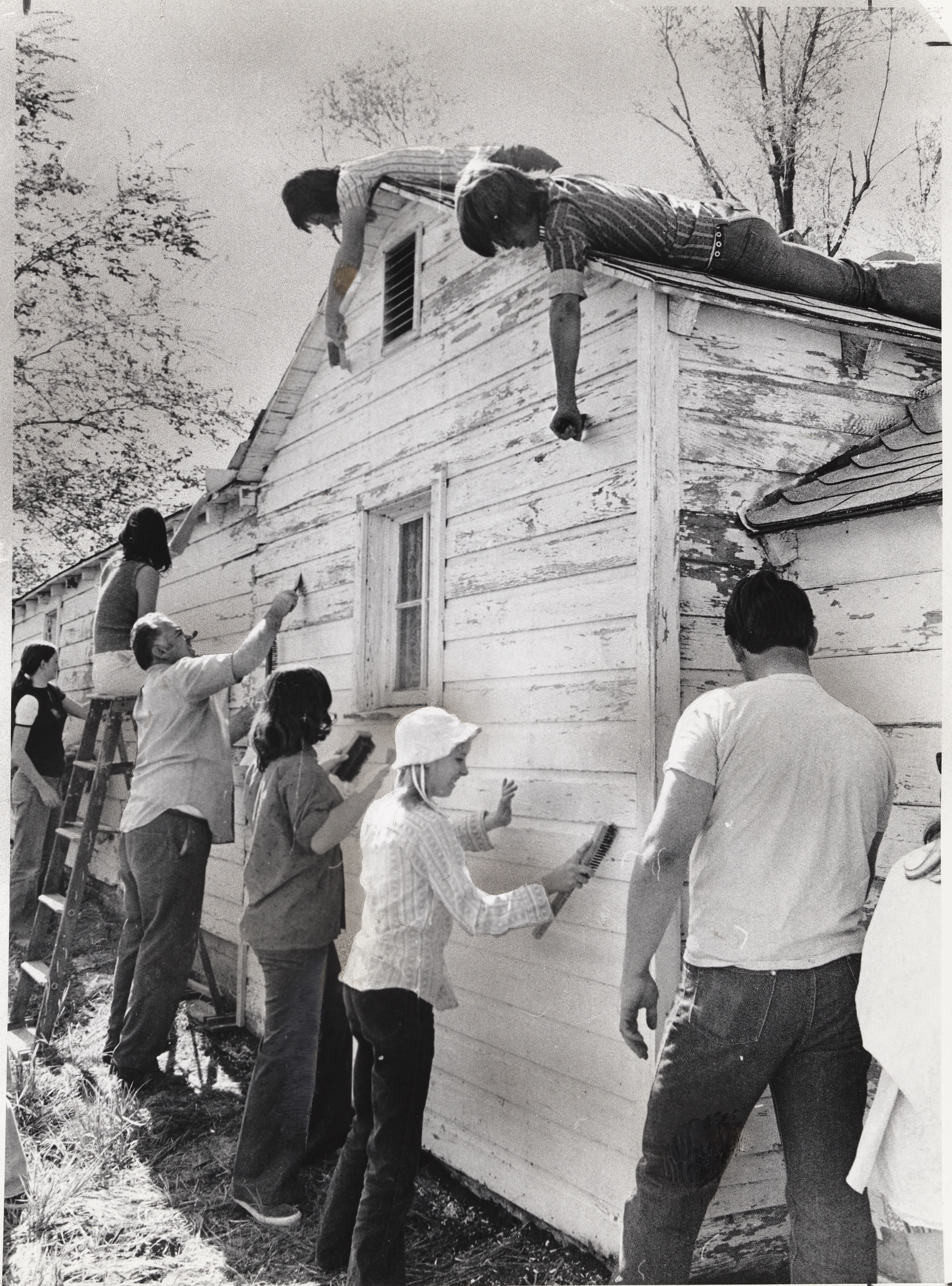 <strong>Youth service project, Bountiful, Utah.</strong> 1974. To commemorate the 145th anniversary of the restoration of the Aaronic Priesthood, youth churchwide were encouraged to help plan local service projects, sporting events, or other group activities. Young men and women in the Bountiful Twenty-Eighth Ward painted the home of a widow in their community. (Image courtesy <em>Church News</em>, copy at Church History Library, Salt Lake City.)