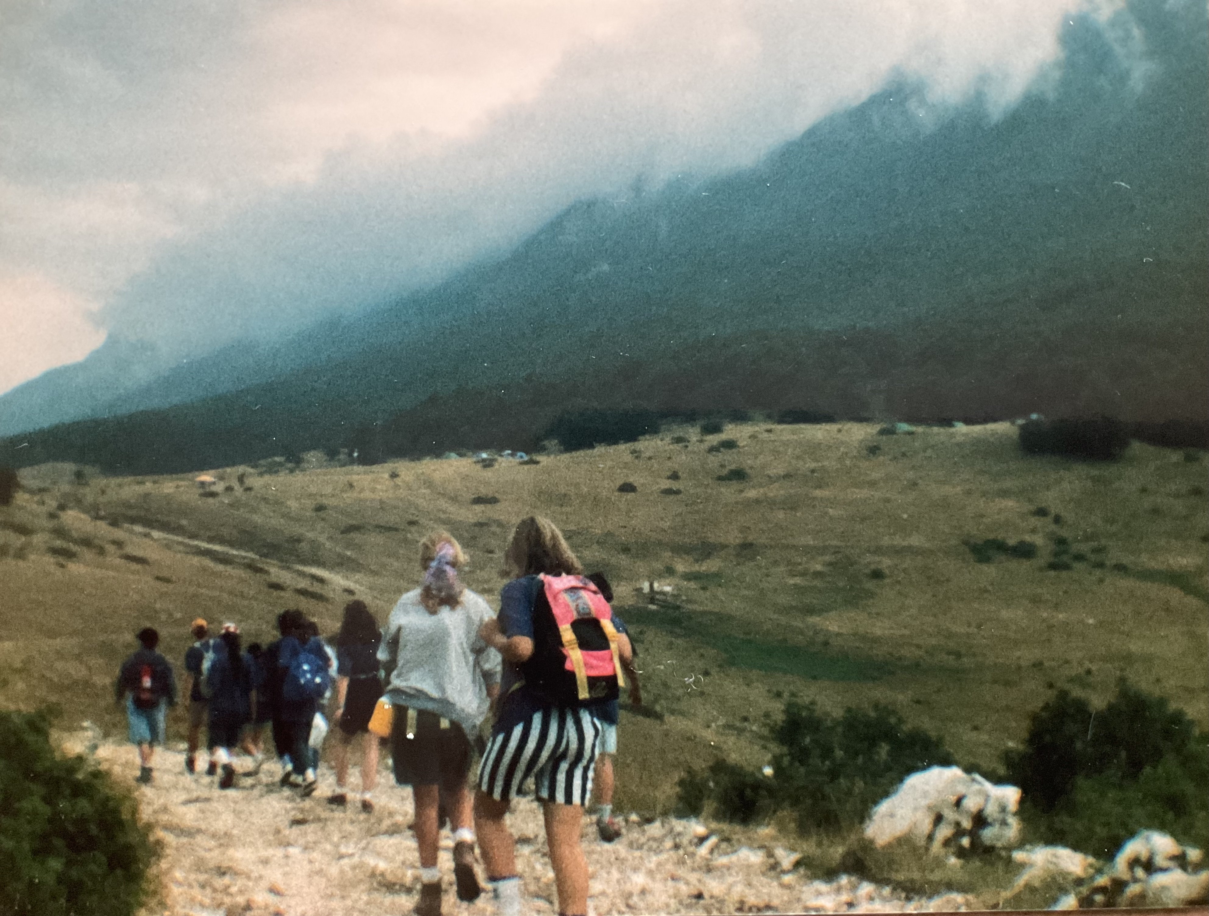 <strong>Young women of Italy hiking as part of <em>Fiaccola Novanta</em>.</strong> 1990. Young women gathered to camp in a rugged area in Abruzzo, Italy, where half the region is dedicated to nature preserves. There they assembled basic structures for their camp, cooked their food outside, hiked several miles, and developed a common sense of identity as young women in the Church of Jesus Christ. (Image courtesy Elisabetta Calabrese.)