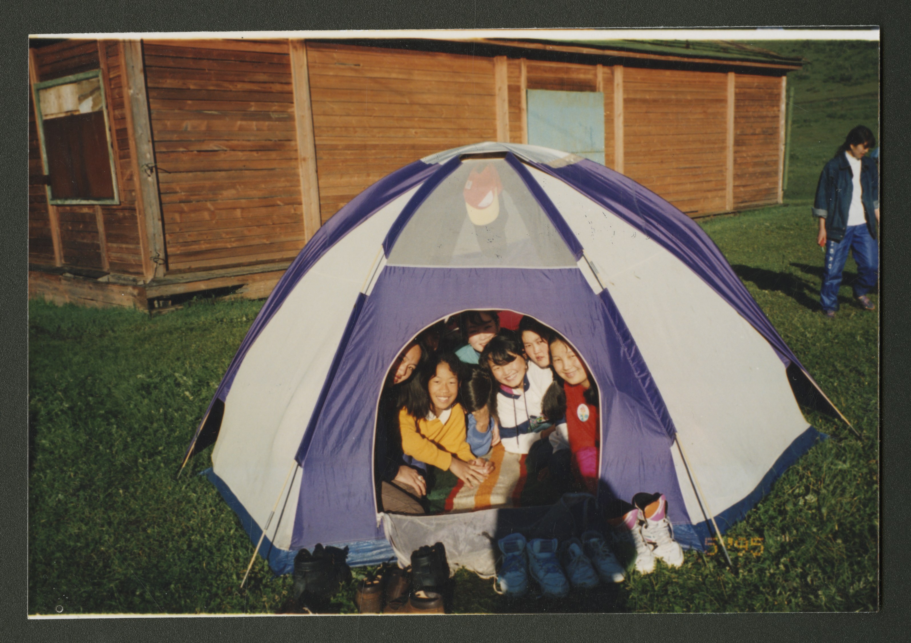 <strong>Young women camp in Mongolia.</strong> 1995. Young women in Mongolia squeezed into tents at the country’s first camp. Despite torrential rains and transportation setbacks, the girls “loved every aspect” of their evening at camp and leaders did not hear a word of complaint (Mary N. Cook, “First Young Women Camp in Mongolia,” <em>New Era</em>, June 2012, 27). Because the first missionaries were allowed into Mongolia only three years earlier, most campers and leaders were new members of the church. As membership continued to grow in new international areas, ongoing efforts to make the Young Women program culturally translatable became increasingly important. (Image courtesy Church History Library, Salt Lake City.)