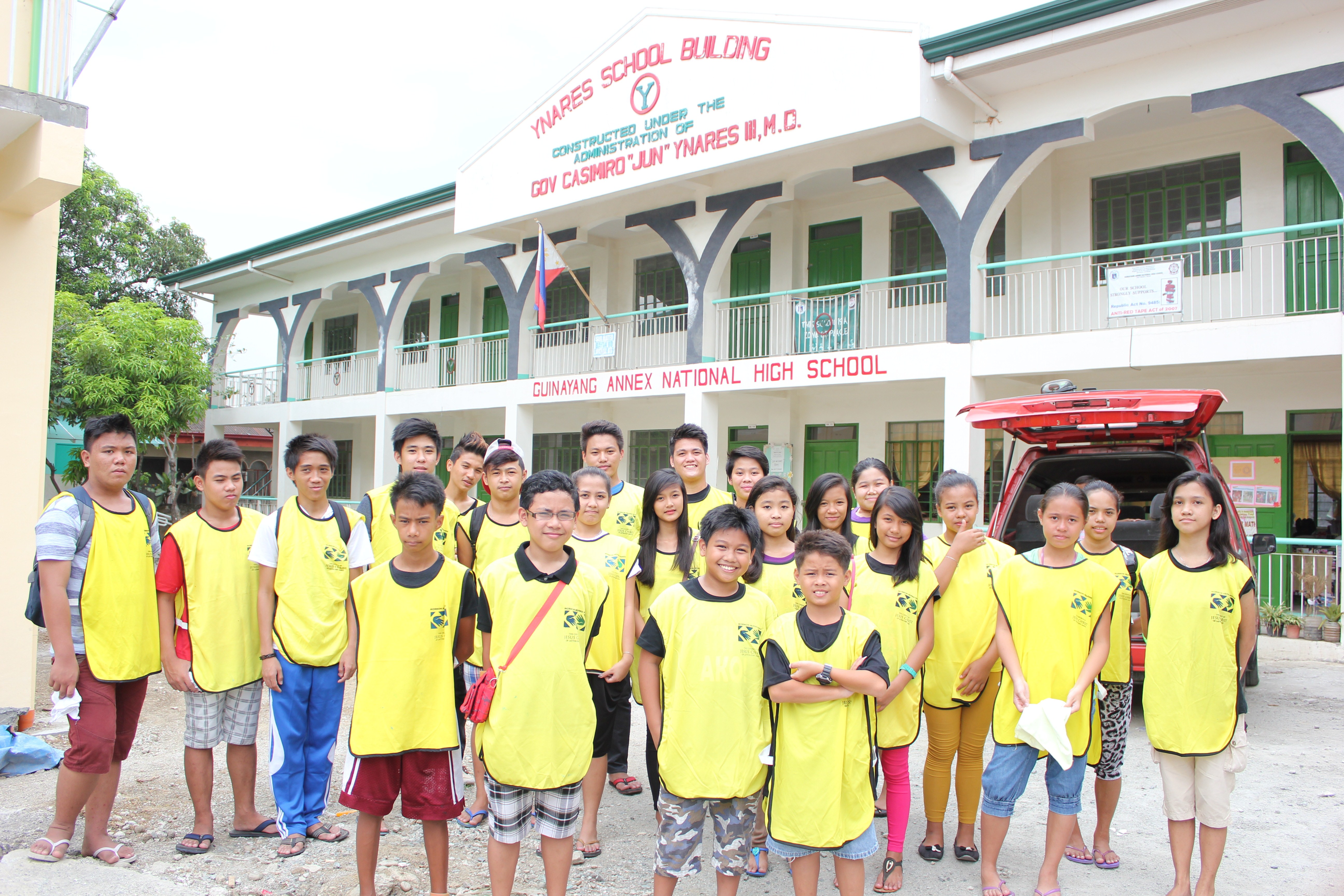 <strong>Youth community service project, Philippines.</strong> 2014. Donning iconic Helping Hands vests, Latter-day Saint youth from the San Mateo Ward in Rizal fixed and painted school chairs at the Casimiro A. Ynares Sr. Memorial National High School. Young women all over the world participated in similar events, ranging from community service to local and international disaster relief. (Image courtesy The Church of Jesus Christ of Latter-day Saints.)