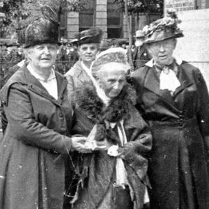 Relief Society general presidency and board members walk south on Main Street in front of their offices at the Bishop’s Building. In front, left to right: Clarissa S. Williams, first counselor; Emmeline B. Wells, president; Julina L. Smith, second counselor. (PH 2032, Church History Library, Salt Lake City.)