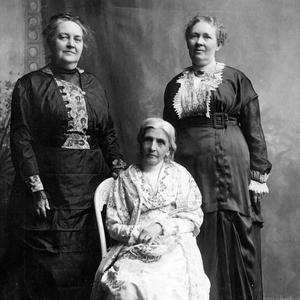 General presidency of the Relief Society from 1910 to 1921. Left to right: Clarissa S. Williams, first counselor; Emmeline B. Wells, seated, president; Julina L. Smith, second counselor. Photograph by the Johnson studio. This photograph appears to have been taken around the same time as a 1914 photograph by the Johnson studio of the presidency with the full board, as the clothing and hairstyles match. (PH 2032, Church History Library, Salt Lake City.)
