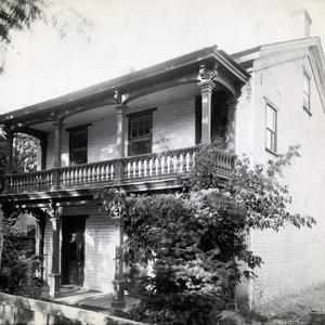 Emmeline B. Wells lived in this two-story home at 243 State Street (or First East), Salt Lake City, between 1856 and 1888. She entertained many friends in the home, including friends of her daughters, and the Wasatch Literary Association was formed here. The garden behind the house with its fruit trees and flowers inspired her poem "The Dear Old Garden." Emmeline's husband, Daniel, and his other wives lived in a different house a few blocks away during this time. In a 5 July 1889 diary entry, Emmeline Wells mentioned going with photographer Charles R. Savage to have her "dear old home" photographed. It is not known if this is the photograph he took. (PH 2356, Church History Library, Salt Lake City.)