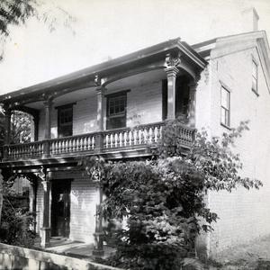 Emmeline B. Wells lived in this two-story home at 243 State Street (or First East), Salt Lake City, between 1856 and 1888. She entertained many friends in the home, including friends of her daughters, and the Wasatch Literary Association was formed here. The garden behind the house with its fruit trees and flowers inspired her poem "The Dear Old Garden." Emmeline's husband, Daniel H. Wells, and his other wives lived in a different house a few blocks away during this time. In a 5 July 1889 diary entry, Emmeline Wells mentioned going with photographer Charles R. Savage to have her "dear old home" photographed. It is not known if this is the photograph he took. (PH 2356, Church History Library, Salt Lake City.)