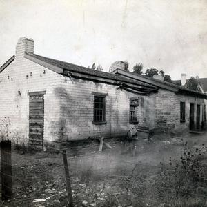 Adobe house, first Utah residence of Daniel H. Wells, on South Temple Street east of the Tithing Yard. Daniel was living here when he married Emmeline B. Woodward in 1852. She moved back to the adobe house in 1888. She moved out in 1893. It was torn down for building the Hotel Utah. This photograph may have been taken in the 1890s. Photograph by Charles R. Savage. (PH 2462, Church History Library, Salt Lake City.)