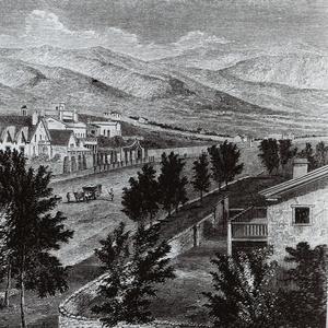 Photograph of an engraving of South Temple Street, Salt Lake City. In the background can be seen the Lion House, Brigham Young’s office, and the Beehive House. In the front on the right is the Daniel H. Wells family home. Across the street from that home (to the north, or the viewer’s left), behind the stone wall, is an adobe house where Emmeline B. Wells lived between February 1888 and December 1893. The engraving was published under the title “The Prophet’s Block” in Randolph B. Marcy, <i>Thirty Years of Army Life on the Border</i> (New York: Harper and Brothers, 1866), p. 262.