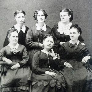 This Charles R. Savage photo of the Salt Lake City Thirteenth Ward Relief Society presidency shows Emmeline B. Wells in the early 1870s. Top row, left to right: Emmeline B. Wells, assistant secretary; Elizabeth H. Goddard, secretary; Mary W. Musser, treasurer. Bottom row: Margaret T. Mitchell, second counselor; Rachel Ivins Grant, president; Bathsheba W. Smith, first counselor.
                                        (PH 8004, Church History Library, Salt Lake City.)