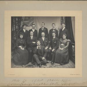 Missionaries pose at the Conference House, 36 Penton Street, London. Eliza Chipman dated the photo 4 January 1899, but the description she wrote on the back closely matches her journal entry of 28 December 1898. Front row (left to right): Chipman, Robert H. Anderson, John R. Hindley, Jabez W. West, George W. Palmer, Inez Knight. Back row: J. Horsley, Frank L. Layton, Raymond Knight, J. W. McFarlane, Joseph R. Squires. Photo by J. S. Dodington, London.
                                        On the back of the photograph, Chipman described the festive gathering and feast, noted that the missionaries had been unable to celebrate Christmas together earlier, and concluded, “The day was one to be long remembered as one of the happiest in England.” (MS 29199, Church History Library, Salt Lake City.)