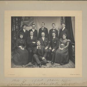 Missionaries pose at the Conference House, 36 Penton Street, London. Eliza Chipman dated the photo 4 January 1899, but the description she wrote on the back closely matches her journal entry of 28 December 1898. Front row (left to right): Chipman, Robert H. Anderson, John R. Hindley, Jabez W. West, George W. Palmer, Inez Knight. Back row: J. Horsley, Frank L. Layton, Raymond Knight, J. W. McFarlane, Joseph R. Squires. Photo by J. S. Dodington, London.
On the back of the photograph, Chipman described the festive gathering and feast, noted that the missionaries had been unable to celebrate Christmas together earlier, and concluded, “The day was one to be long remembered as one of the happiest in England.” (MS 29199, Church History Library, Salt Lake City.)