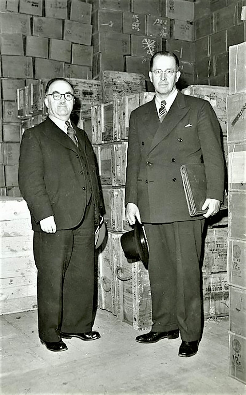 Elder Benson and Pres. Zimmer Checking Welfare Supplies, Circa 1946