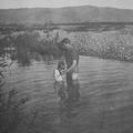 Elder Dastrup baptizing Neville Thomas in the Otaki River, NZ